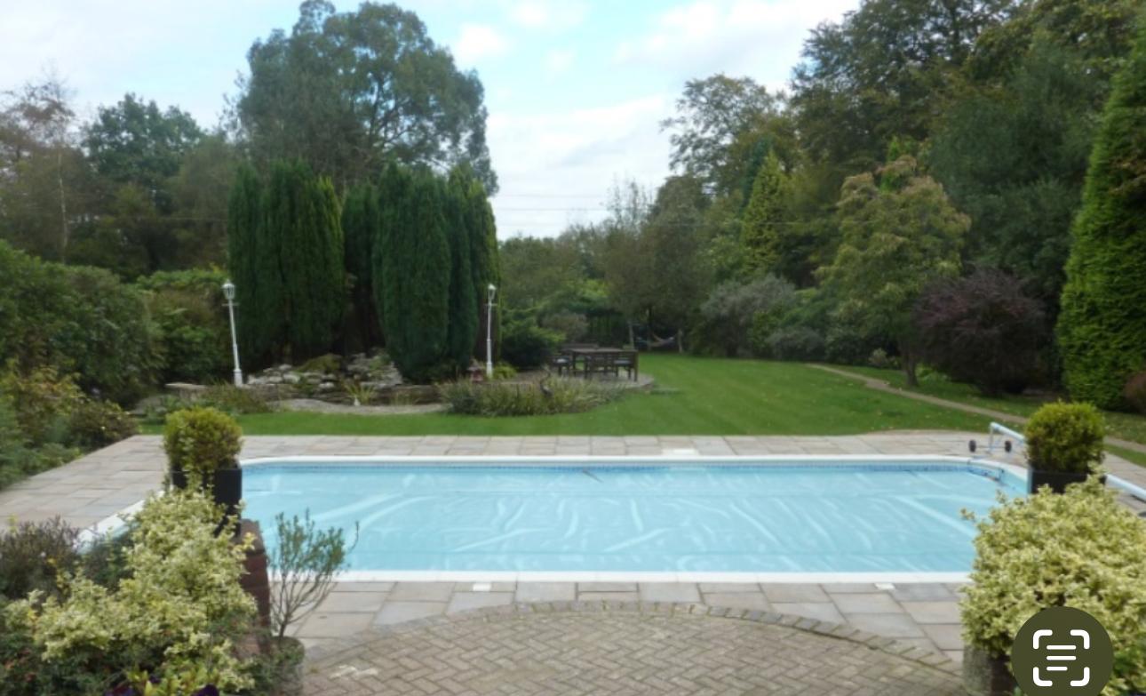 Finished outdoor swimming pool in a landscaped garden